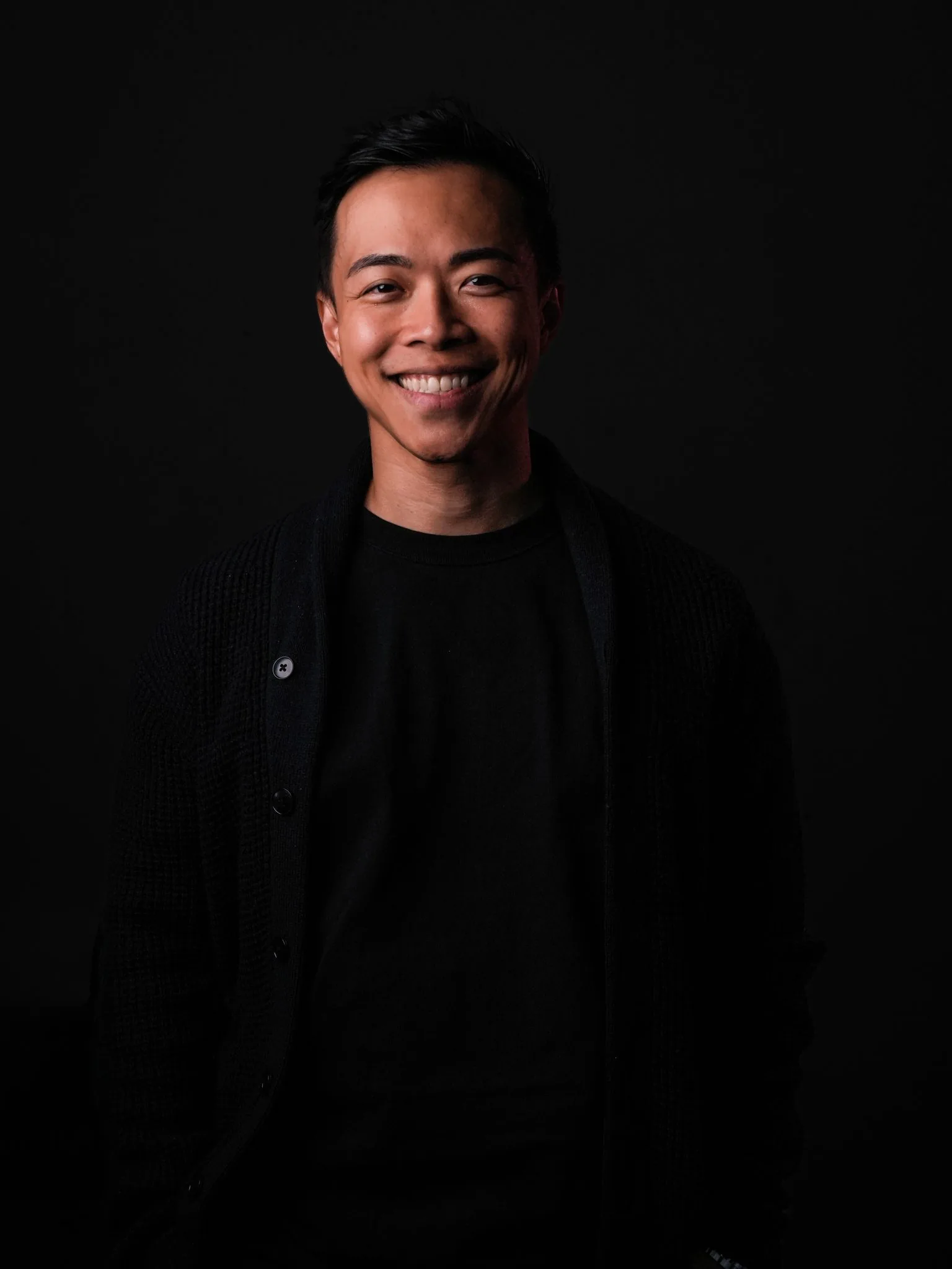 Pete, founder of Young Guns Studio, smiling in a dark cardigan